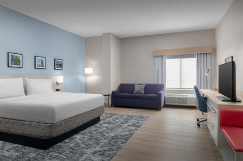 a hotel room with a bed and a couch and a desk at Hilton Garden Inn Wilkes-Barre in Wilkes-Barre