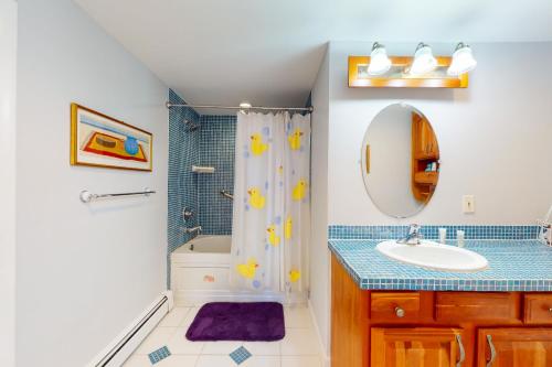 a bathroom with a sink and a shower at Mill View: La Maison de l'Artiste in Falmouth