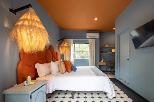 a bedroom with a large bed with a large headboard at HOLT Art Deco Retreat in Vibrant 3 Bedroom Villa in San Miguel de Allende