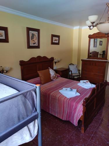 a bedroom with two beds and a mirror at Casa Rural Chalet Venta del Aire Cortijo Terron in Lanjarón