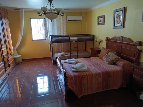 a bedroom with a large bed and a window at Casa Rural Chalet Venta del Aire Cortijo Terron in Lanjarón