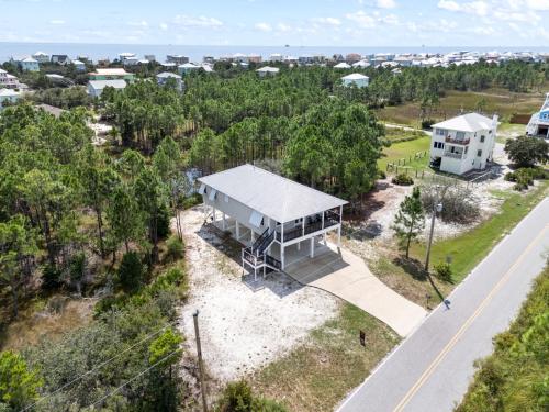 an overhead view of a white house and a road at Beach Please in Gulf Shores