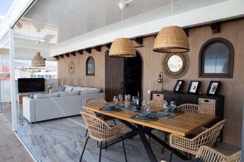 a living room with a wooden table and chairs at BlueAttic La Mareta in La Mareta