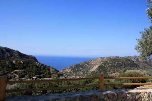a fence with the ocean in the background at Christos Place-Anidri in Palaiochóra