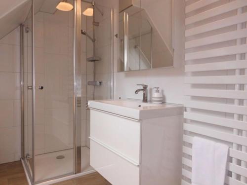 a white bathroom with a sink and a shower at Holiday apartment Haus Bodefurt - Apartment 2 in Altenbrak
