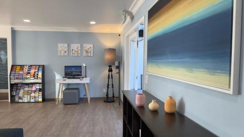 a living room with a large painting on the wall at Marina Village Inn in Alameda
