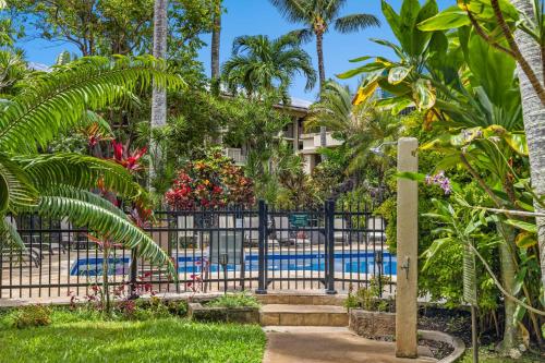 a fence with a pool in front of a resort at Prince Kuhio 110 in Koloa