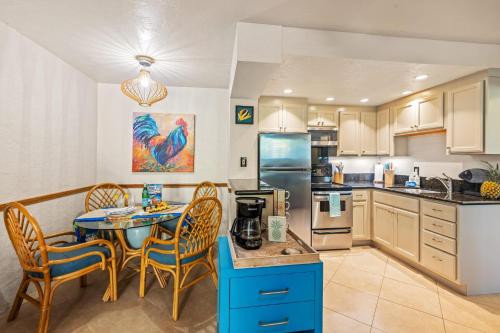 a kitchen with a table and chairs and a dining room at Prince Kuhio 110 in Koloa