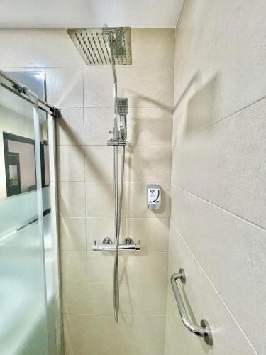 a shower with a shower head in a bathroom at Piropos de Doñana in El Rocío