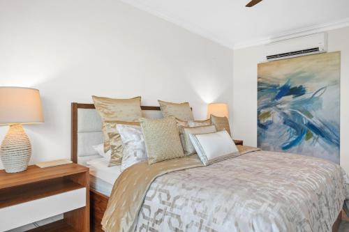 a bedroom with a bed and a painting on the wall at Beach & Golf Course Views in Rio Grande