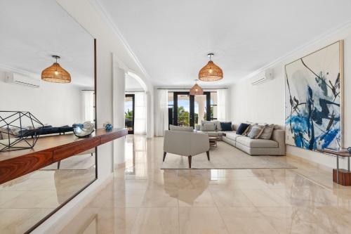 a living room with a couch and a table at Beach & Golf Course Views in Rio Grande