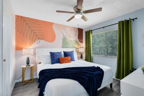 a bedroom with a bed and a ceiling fan at Oasis 201 - Dune Dream in Titusville