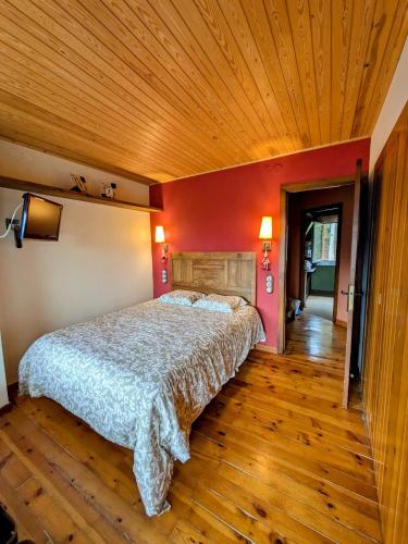 a bedroom with a large bed with a wooden ceiling at La Molina Tranquil Escape in La Molina