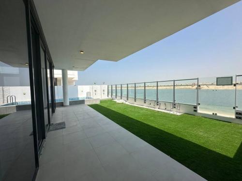 an empty building with a view of the ocean at Ajmal Chalet in Al Ḩamrīyah