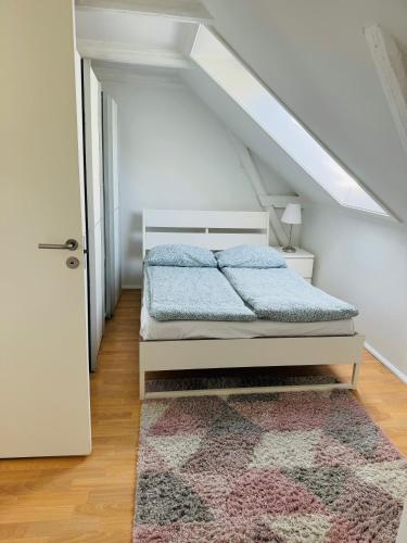 a bedroom with a bed with a rug and a door at Cozy 2-room Apartment in Aarhus
