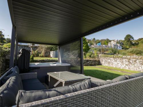 a screened in patio with a table and chairs at Argyle House in Rothesay