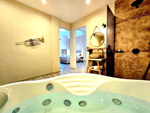 a bathroom with a bath tub in a room at Golden City Center Suites in Rhodes Town