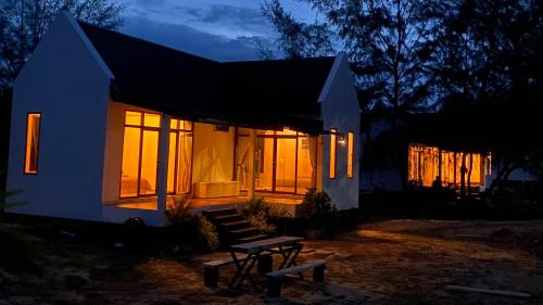 a house with a bench in front of it at night at 4U Resort & Camp in Ban Kampong Ba-Ru