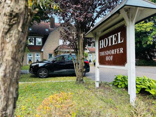 a sign for a hotel thermoffenoserhump with a car parked in at Hotel Thesdorfer Hof in Pinneberg