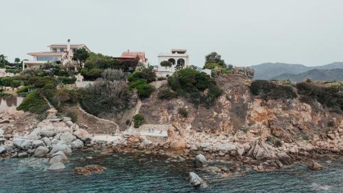a rocky island with houses on it in the water at Casa Gioia in Maracalagonis