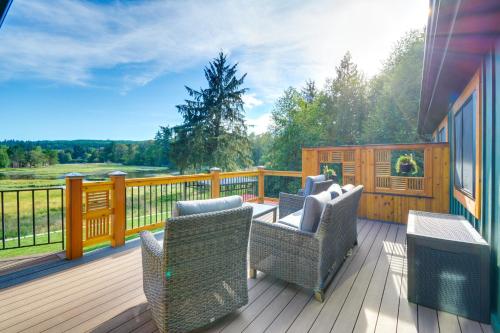 a deck with two chairs and a table with a view at Washington Gem on 8 5 Acres Clamming Nearby! in Port Ludlow