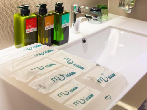 a bathroom sink with two bottles ofodorizers on it at Hotel MU in Zhongli