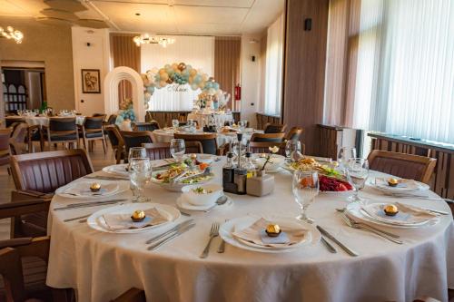 a table with plates of food on it in a restaurant at Hotel Montana SPA in Kruševo