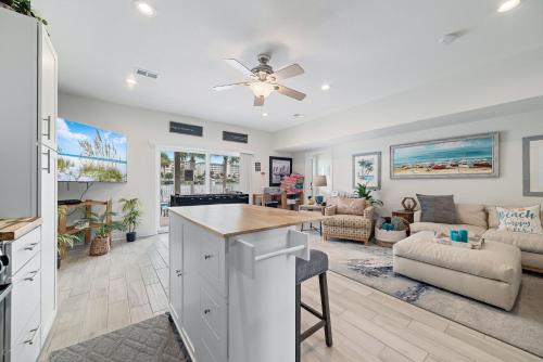 a kitchen and living room with a ceiling fan at The Yellow House South at Herons Walk in Pensacola