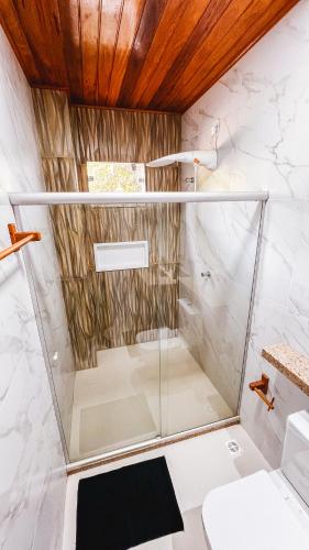 a glass shower in a bathroom with a toilet at Sunset Beach in Barra Grande