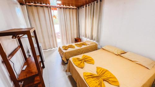a room with two beds and a window at Sunset Beach in Barra Grande