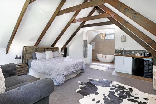 a attic bedroom with a bed and a bathroom at Waterfront Stay, Pet Friendly 1 Night Stays! in St Georges Basin