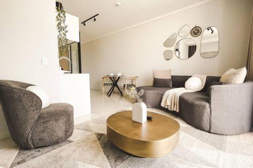 a living room with a couch and a table at Beautiful Galena at Ellipse in Midrand