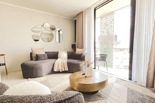 a living room with a couch and a coffee table at Beautiful Galena at Ellipse in Midrand