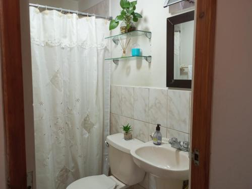 un baño con inodoro y lavabo en Habitación con vista al mar, en Lima
