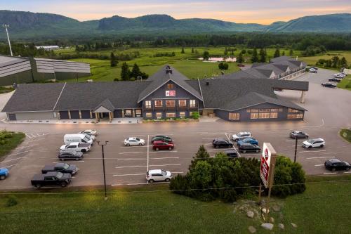 a large building with cars parked in a parking lot at Best Western Plus NorWester Hotel & Conference Centre in Thunder Bay