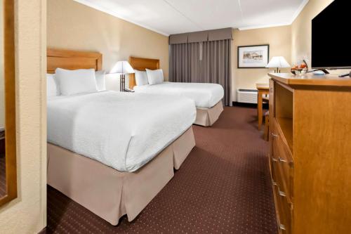 a hotel room with two beds and a television at Best Western Plus NorWester Hotel & Conference Centre in Thunder Bay