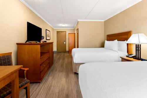 a hotel room with two beds and a television at Best Western Plus NorWester Hotel & Conference Centre in Thunder Bay
