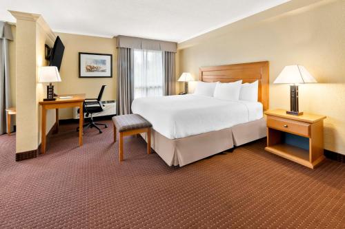 a hotel room with a large bed and a desk at Best Western Plus NorWester Hotel & Conference Centre in Thunder Bay
