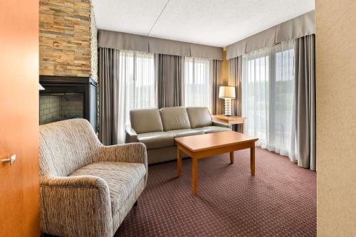 a living room with a couch and a chair at Best Western Plus NorWester Hotel & Conference Centre in Thunder Bay