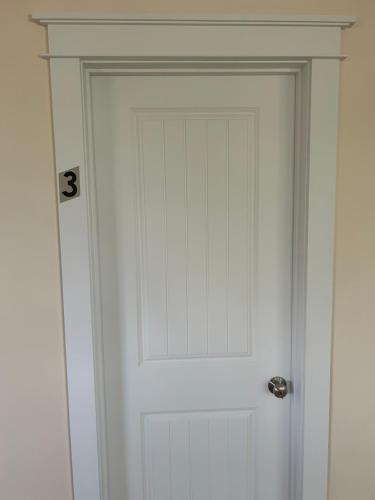 a white door with the number on it at Roberts Lake House Room #3 in Colchester