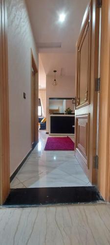 a hallway of a house with a room with a door at Appartement meublé in Ville Nouvelle