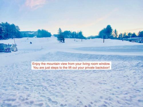 a picture of a snow covered field with a sign at True Upscale Ski In & Out Condo with Pool & Hot Tub in Conway