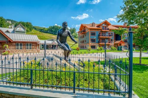 a statue of a man jumping over a fence at True Upscale Ski In & Out Condo with Pool & Hot Tub in Conway