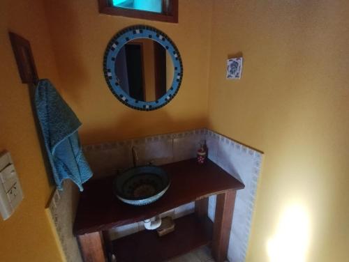 a bathroom with a sink and a mirror on the wall at De viento y luna in General Pico