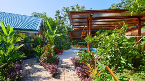 a garden with a swimming pool and plants at Casa Blossom - Beach Paradise Retreat, Fully Equipped, Holiday Home in Puerto Viejo