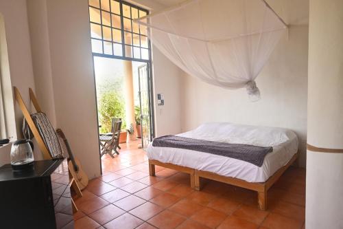 a bedroom with a bed and a large window at Sky Temple Yelapa in Yelapa