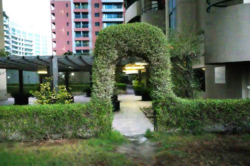 an arch covered in ivy next to a building at Pathfinder Partition Room in Barsha Heights Tecom in Dubai