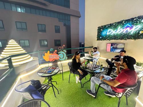 a group of people sitting at tables on a balcony at Pathfinder Partition Room in Barsha Heights Tecom in Dubai