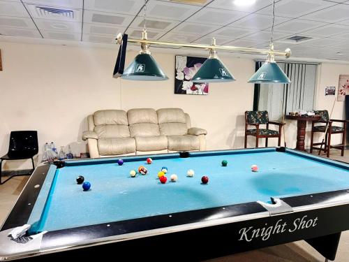 a living room with a pool table at Pathfinder Partition Room in Barsha Heights Tecom in Dubai