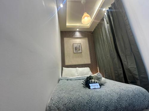 a small bedroom with a bed with a sign on it at Pathfinder Partition Room in Barsha Heights Tecom in Dubai
